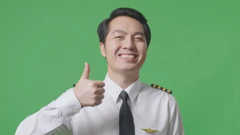 Man Pilot Smiling And Showing Thumbs Up Gesture To Camera Standing Green Screen Stock Footage 244395543