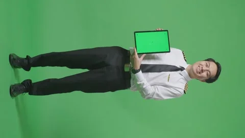 Man Pilot Smiling And Showing Green Screen Tablet To The Camera Green Screen Stock Footage 244401044