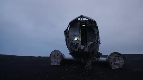 Man in pilot suit in a wrecked plane on an Iceland beach Video stock 104240596