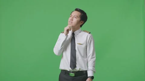 Man Pilot Thinking About Something And Looking Around Standing On Green Screen Stock Footage 244393242