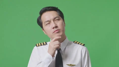 Man Pilot Thinking About Something And Looking Around Standing On Green Screen Stock Footage 244395646