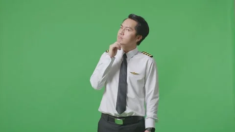 Man Pilot Thinking And Looking Around Then Raising His Index Finger Green Screen Stock Footage 244393254