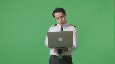 Man Pilot Using A Laptop And Having A Headache While Standing On Green Screen Stock Footage 244394698