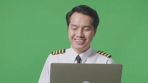 Man Pilot Using A Laptop And Pointing To Side While Standing In The Green Screen Stock Footage 244398071