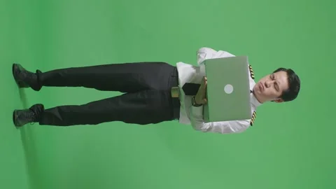 Man Pilot Using A Laptop And Having A Headache While Standing On Green Screen Stock Footage 244400584
