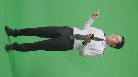 Man Pilot Using Smartphone And Pointing To Side While Standing On Green Screen Stock Footage 244400209