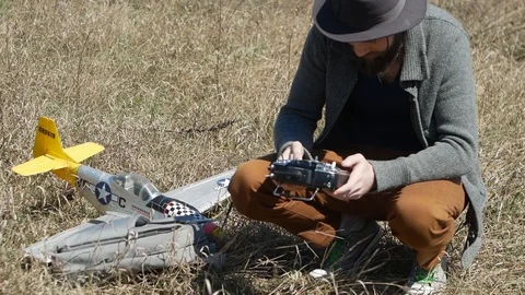 Man Piloting Tiny Radio Controlled Helicopter With Radio Remote Control outdoor. Stock Footage 128988803