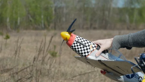 Man Piloting Tiny Radio Controlled Helicopter With Radio Remote Control outdoor. Stock Footage 128988824