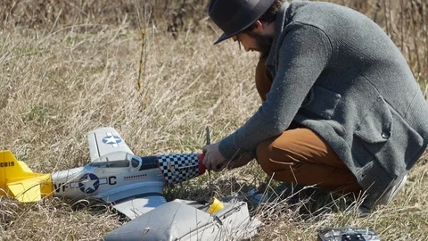 Man Piloting Tiny Radio Controlled Helicopter With Radio Remote Control outdoor. Stock Footage 128988831
