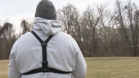 Man pilots a drone in an empty field 4K Stock Footage 101855197