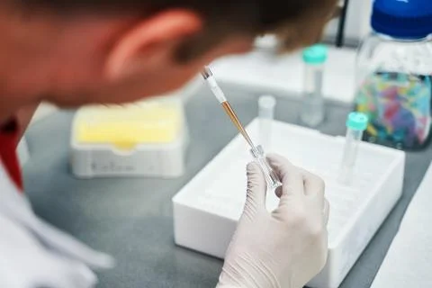 Man with pipette in lab Stock Photos