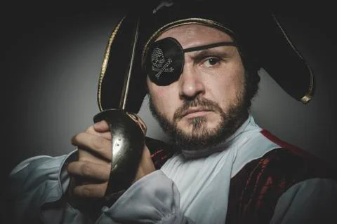 Man pirate with eye patch and old hat with funny faces and expressive Stock Photos
