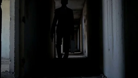 A man with a pistol and case is walking Stock Footage 75944915