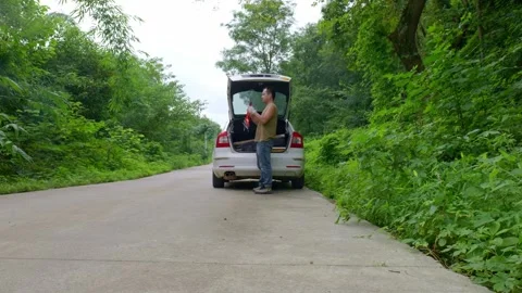 Man placed a warning triangle behind his car after it broke down Stock Footage 316795041