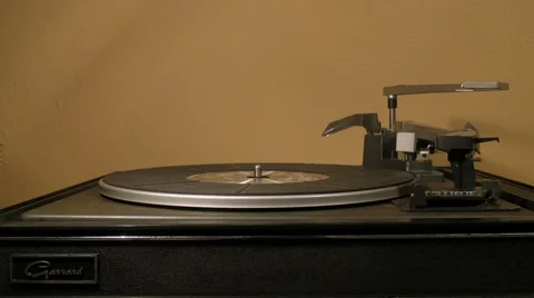 Man places 33 LP record on 1960s turntable v1 Stock Footage 5503538