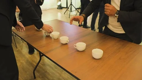 A man places coffee cups on the table 스톡 동영상 328047621