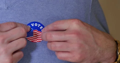 Man Places I Voted Sticker on Chest Stock Footage