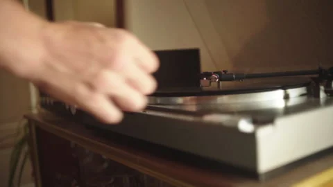 A man places the needle of a turntable on a record. Stock Footage 265073481
