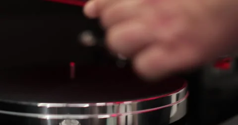 Man places a red disk on a vinyl player. Classic vinyl record player. Stock Footage 296400460