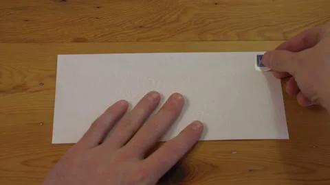 Man Places Stamp on Blank Envelope, First Person Point of View Stock Footage 149076883
