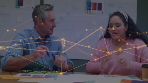 Man placing blue marker, sliding layout to woman, both annotating business Stock Footage 313149680