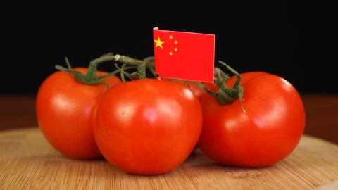 Man placing decorative toothpick with flag of China into bunch of tomatoes. Stock Footage 152788381