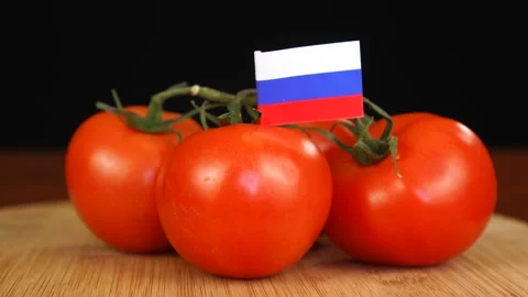 Man placing decorative toothpick with flag of Russia into bunch of tomatoes. Stock Footage 152793265
