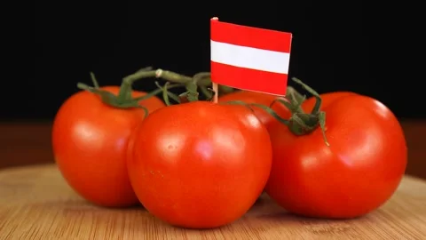 Man placing decorative toothpick with flag of Austria into bunch of tomatoes. Stock Footage 152795256