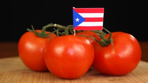 Man placing decorative toothpick with flag of Puerto-Rico into bunch of tomatoes Stock Footage 152795427