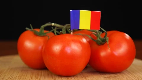 Man placing decorative toothpick with flag of Romania into bunch of tomatoes. Stock Footage 152795885