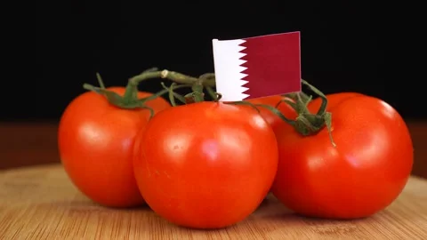 Man placing decorative toothpick with flag of Qatar into bunch of tomatoes. Stock Footage 152796931
