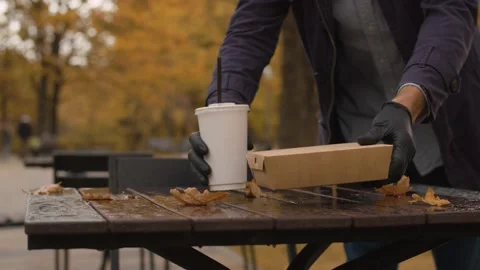 A man placing fast food on the table Stock Footage 141284973
