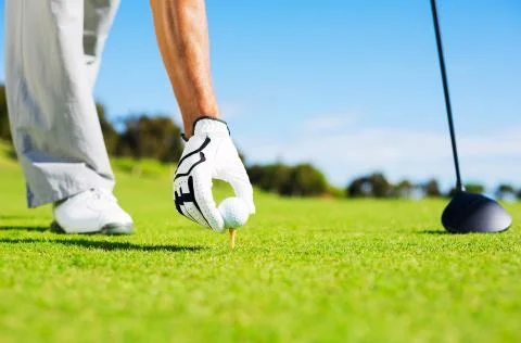 Man placing golf ball on tee 스톡 사진