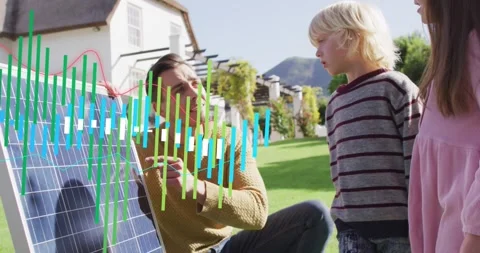 Man placing hand on solar panel, holding red wire and teaching kids while Stock Footage 334040615