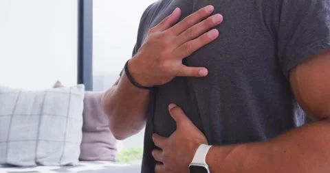 Man placing hands on chest and belly, checking heartbeat and breathing with Stock Footage 340011711