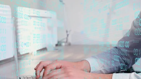 Man placing hands on keyboard as camera shifts down, typing code under binary Stock Footage 334810853