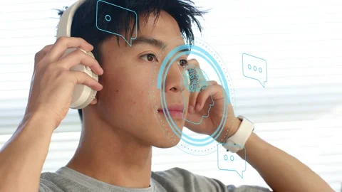 Man placing headphones, causing blue AR HUD with brain and audio bubbles, Stock Footage 335255257