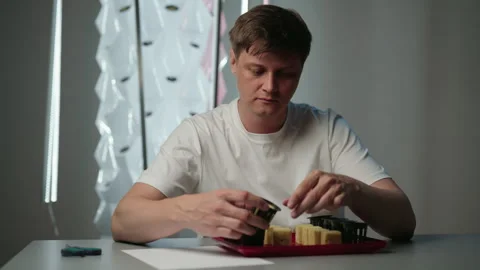 Man placing rockwool growing cubes into net pots, preparing plant seeds for Stock Footage 320216616