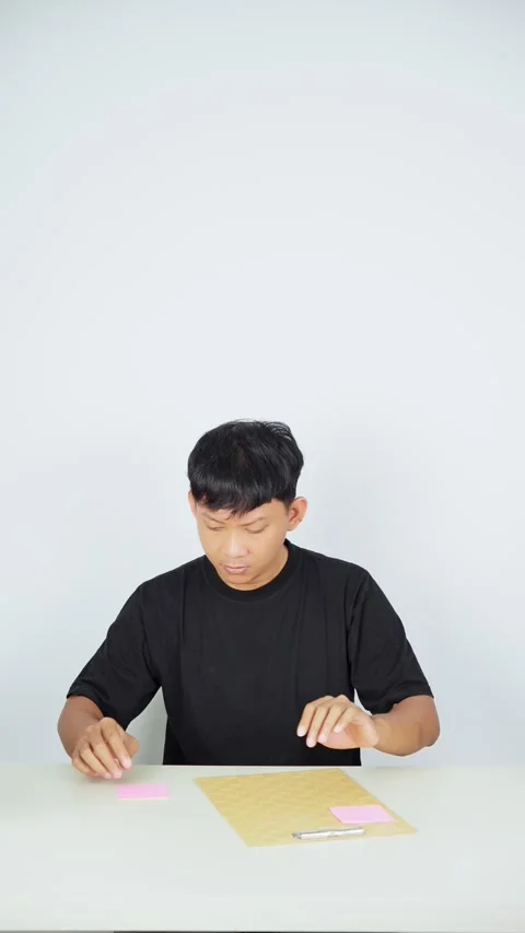Man Placing Sticky Note on White Background Video stock 347105162