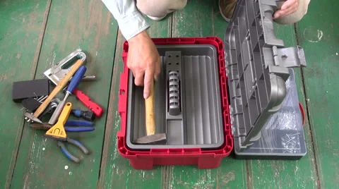 Man placing tools into tool box Stock Footage 66649276