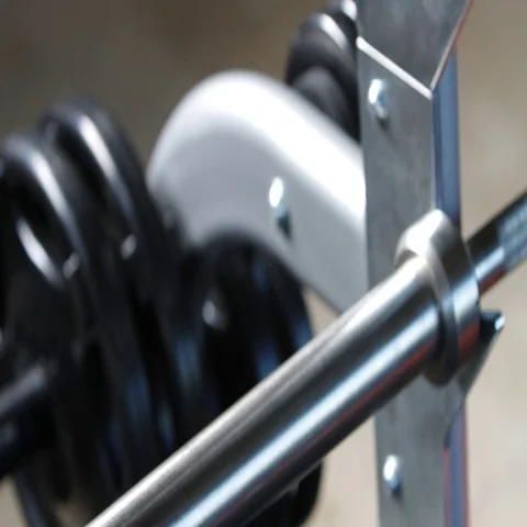 Man placing weight on barbell Stock Footage 69718286