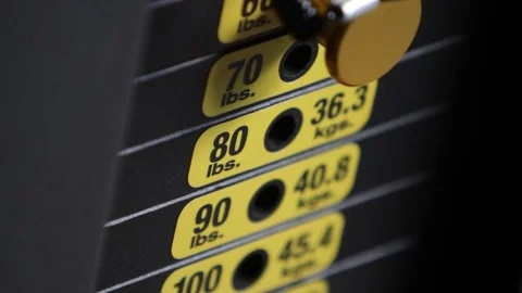 Man Placing Weight Pin Stock Footage 69718400