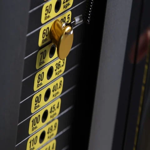 Man placing weight pin Stock Footage 69718824