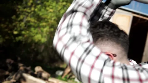 Man in Plaid Cuts Wood with Axe in Slow Motion Stock Footage 142340201