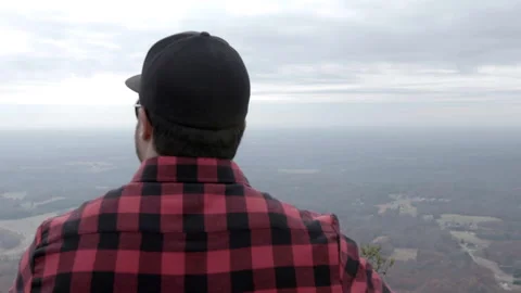 Man in Plaid Shirt Overlooking Mountain Valley Stock Footage 343933763