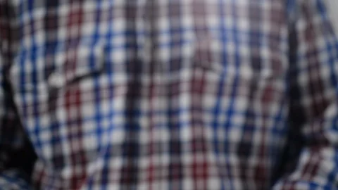 A man in a plaid shirt writes in a notebook.Soft focus. Stock Footage 104064650