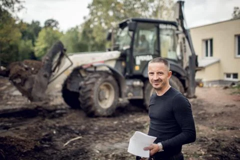 Man with plan of working in his hand is as a customer  on the construction sit Stock Photos