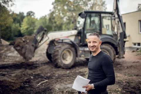 Man with plan of working in his hand is as a customer  on the construction sit Stock Photos