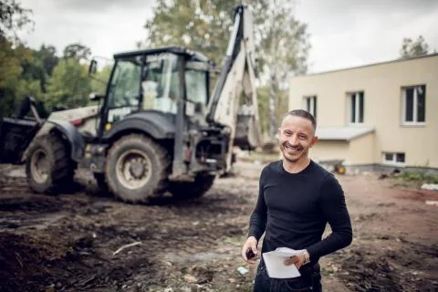 Man with plan of working in his hand is as a customer  on the construction sit Stock Photos