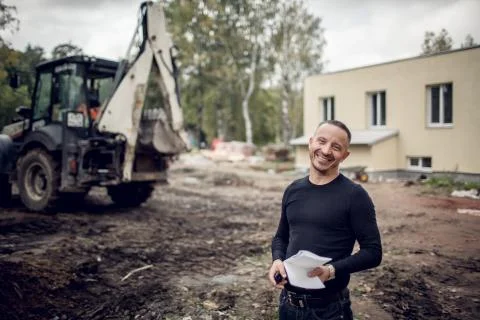 Man with plan of working in his hand is as a customer  on the construction sit Stock Photos
